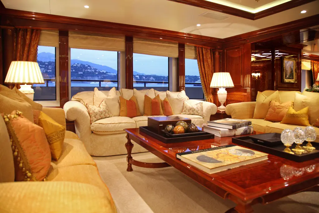 Saloon with cream sofas, lacquered wood panelling and large windows