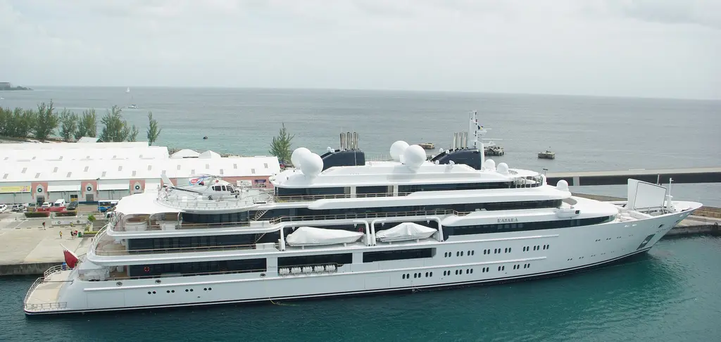 Katara moored alongside a quay, seen from above, with a helicopter on the aft deck
