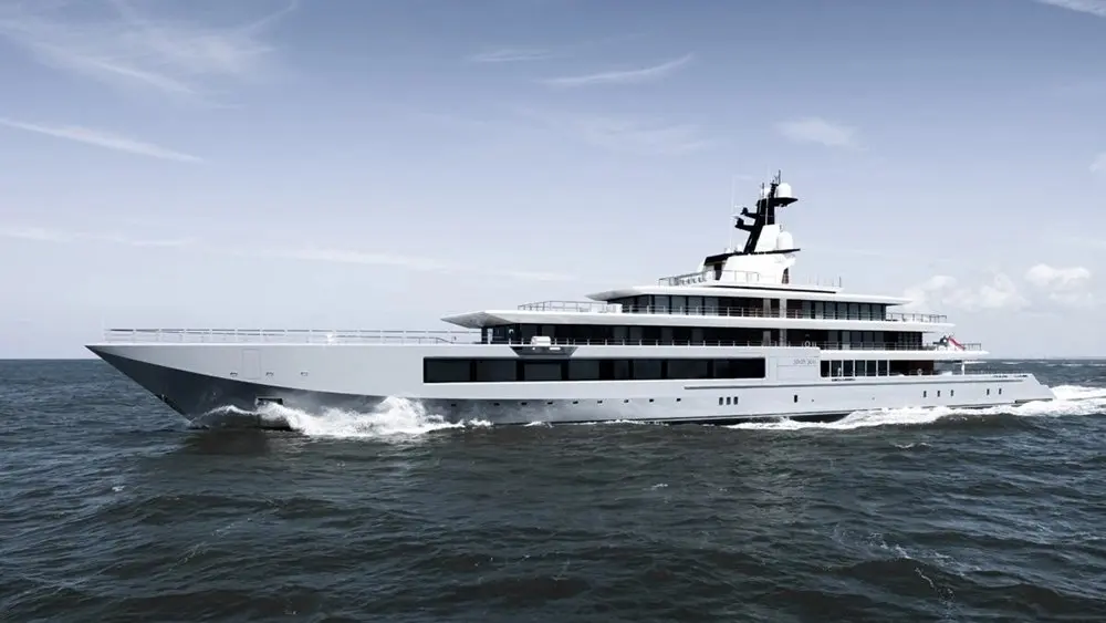 Seven Seas in full port-side profile at speed, with a grey hull and three tiers of glazed superstructure