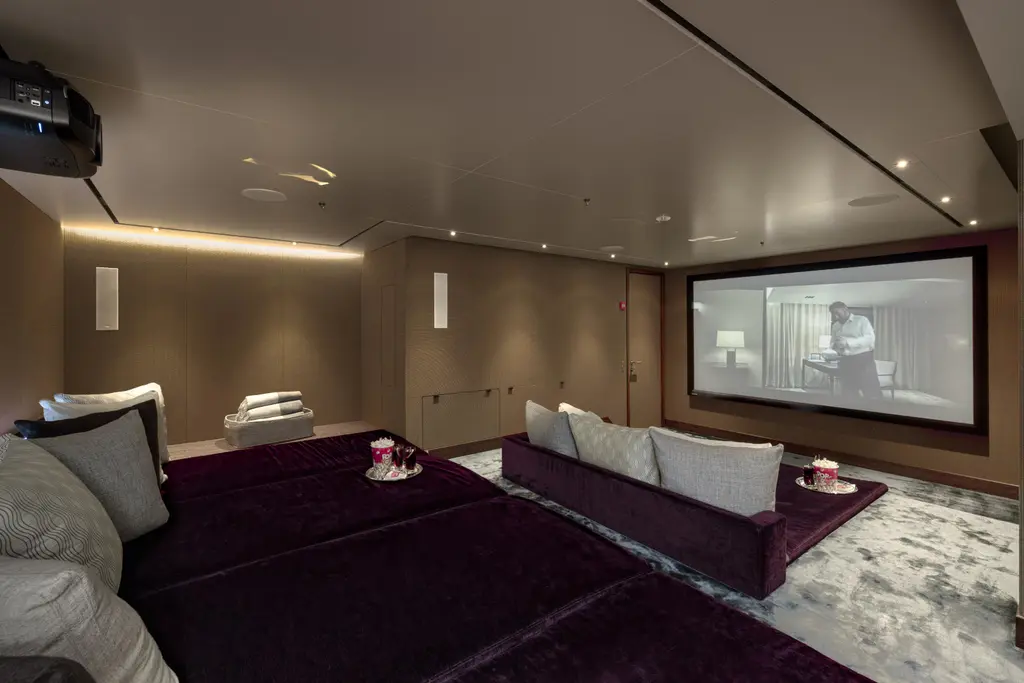 Cinema room with deep sofas facing a large screen