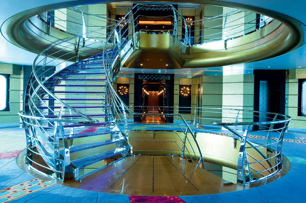 Spiral staircase with steel balustrades rising through a round atrium
