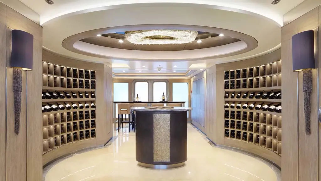 Wine room with curved wall racks of bottles and a central tasting table