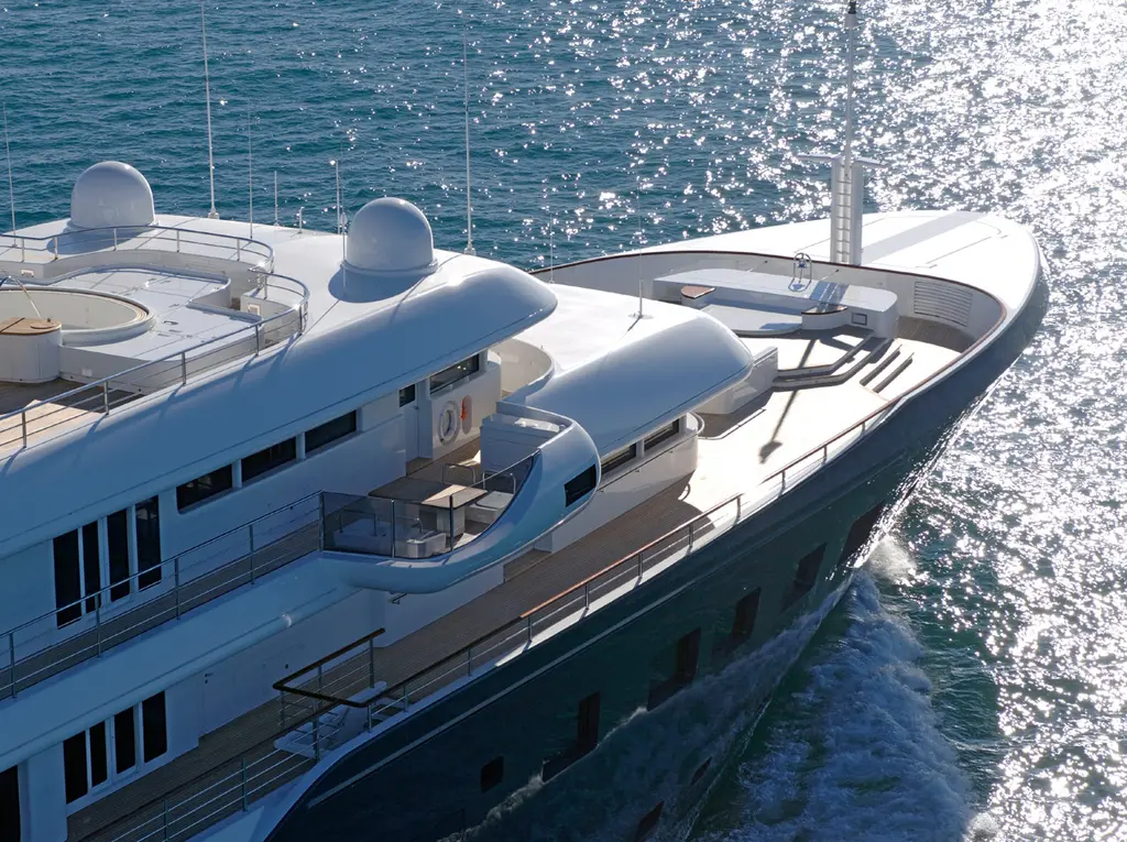 Aerial close-up of the forward superstructure and foredeck as the yacht moves through sunlit water