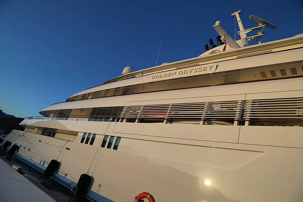 Low-angle view along Golden Odyssey's side with her name on the upper deck