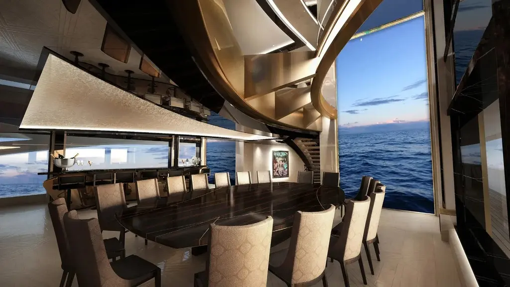 Dining room with a long table and floor-to-ceiling windows to the sea
