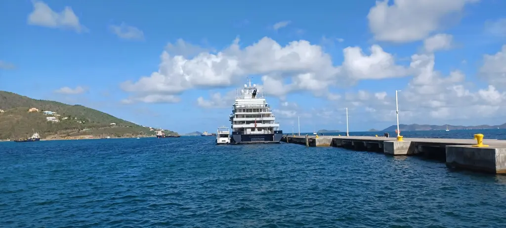 Multiverse at the end of a long pier in a sunny island harbour