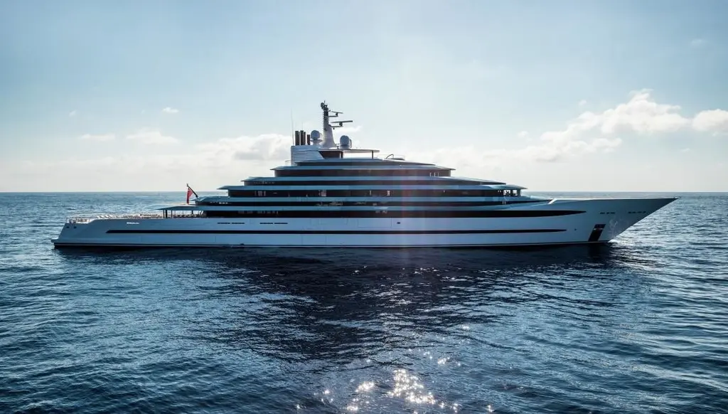 The white hull and layered superstructure in profile on open water