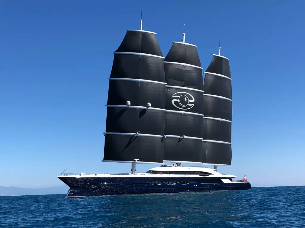 Black Pearl from the side with all three square-rigged sails set, the yards curving across each black sail