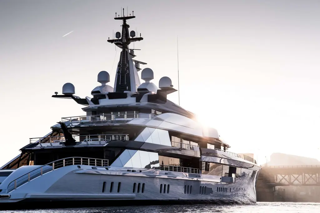 Close view of the superstructure and mast of Bravo Eugenia with radar domes, backlit by low sun