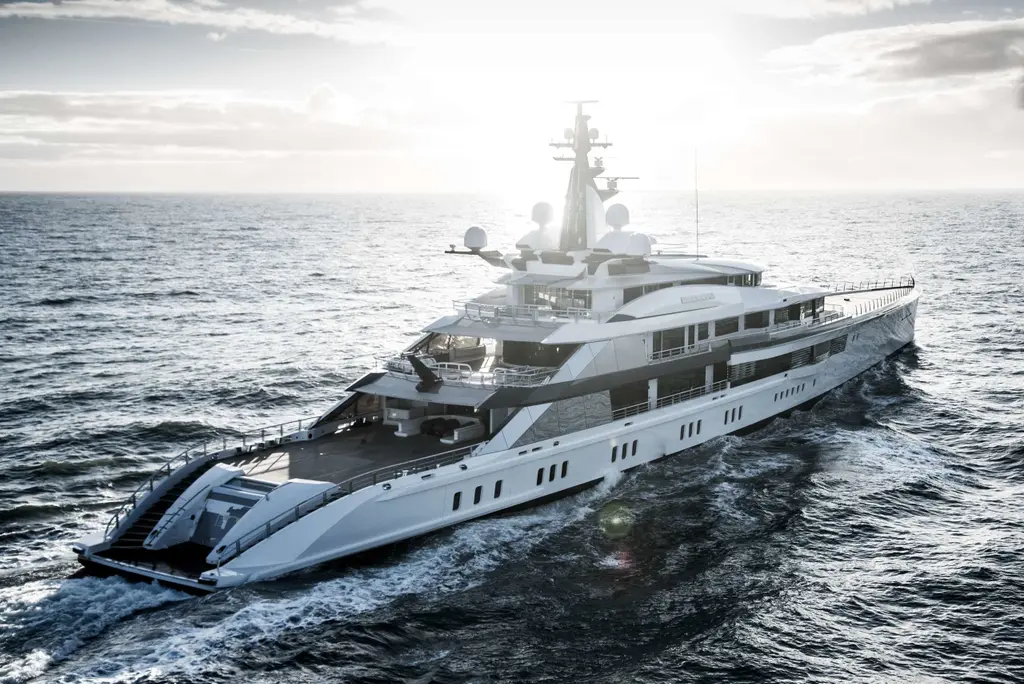 Bravo Eugenia from her starboard quarter at sea, with twin staircases descending to the stern platform