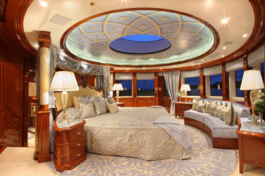 Stateroom with a domed ceiling and skylight, double bed and curved sofa