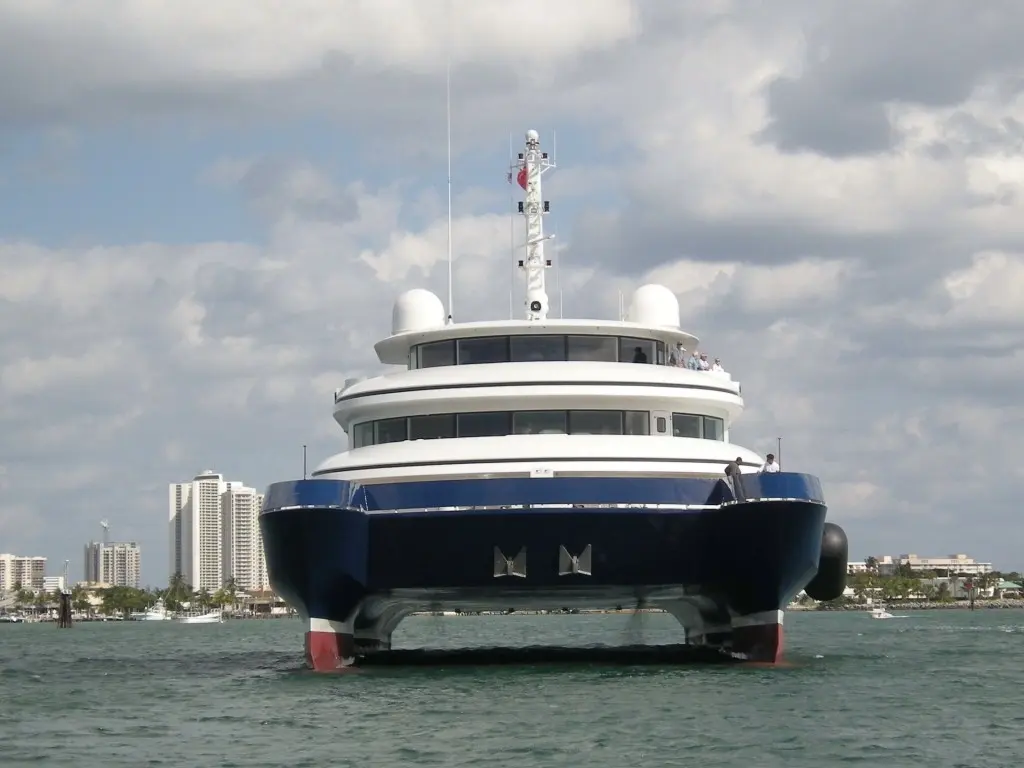 Silver Cloud seen bow-on at anchor, with open water between the two hulls under the platform