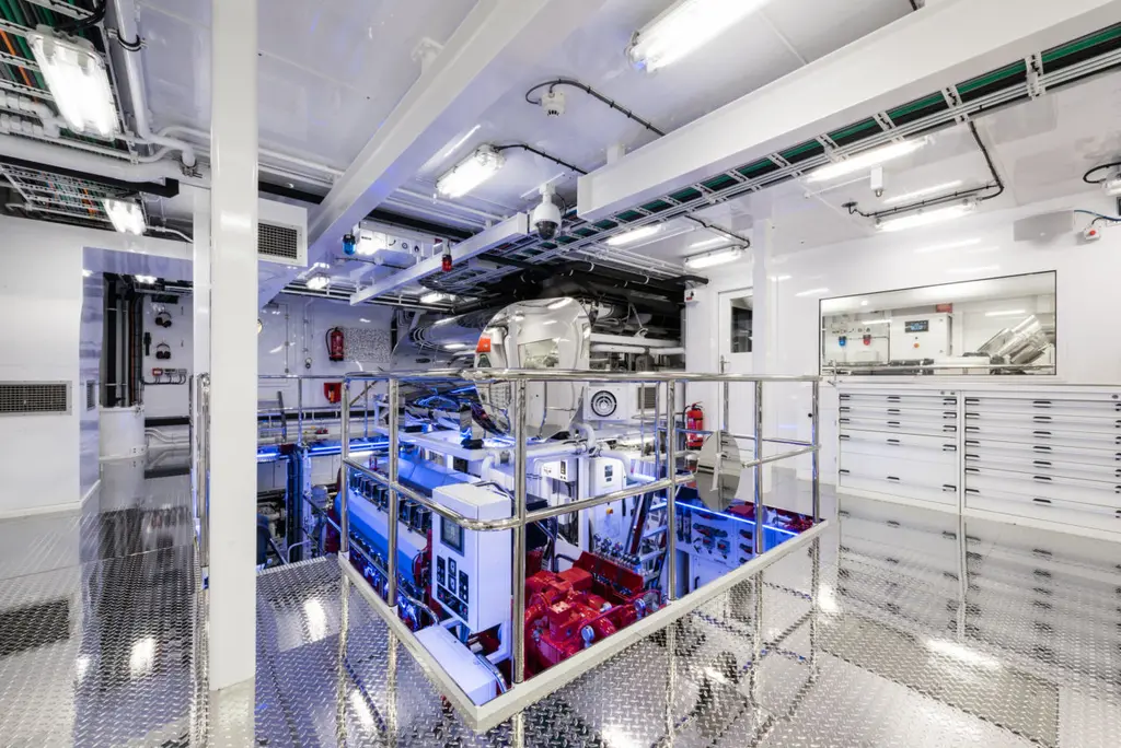 Savannah's engine room seen from a gallery, with white panels and blue machinery below