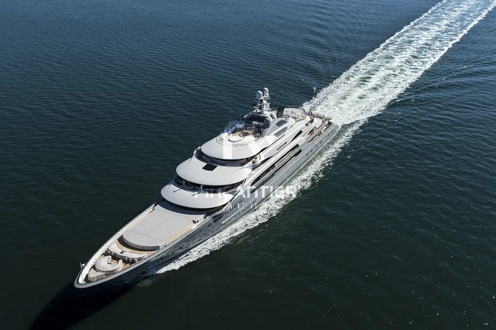 Aerial view of Ocean Victory under way, bow towards the camera, with a long white wake