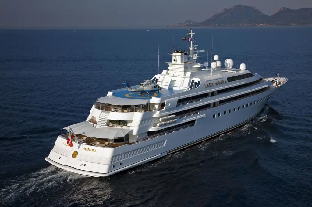 Lady Moura from the stern quarter, the aft decks stepping down to the water