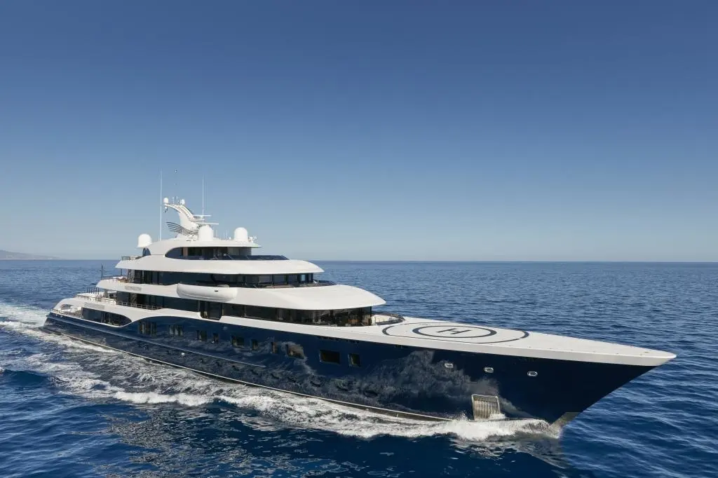 Symphony underway at speed seen from the starboard bow, with the helicopter landing circle on her foredeck