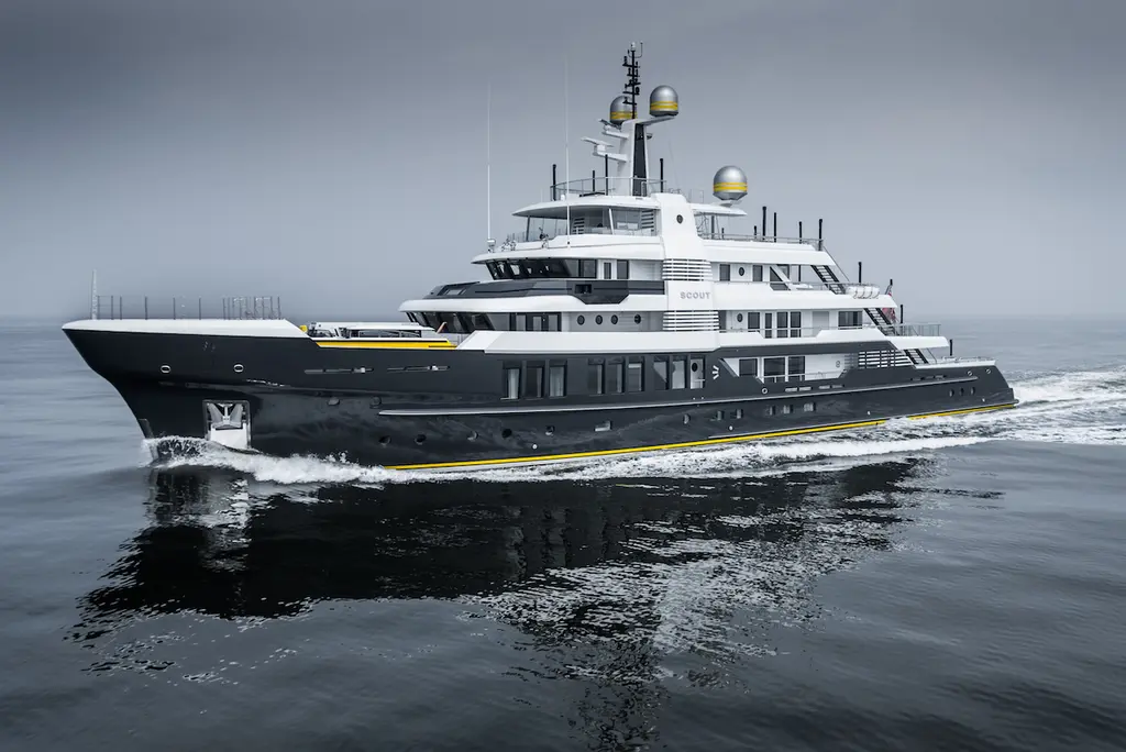 Scout in port-side profile at sea, showing the high bow, the long foredeck and four decks of white superstructure