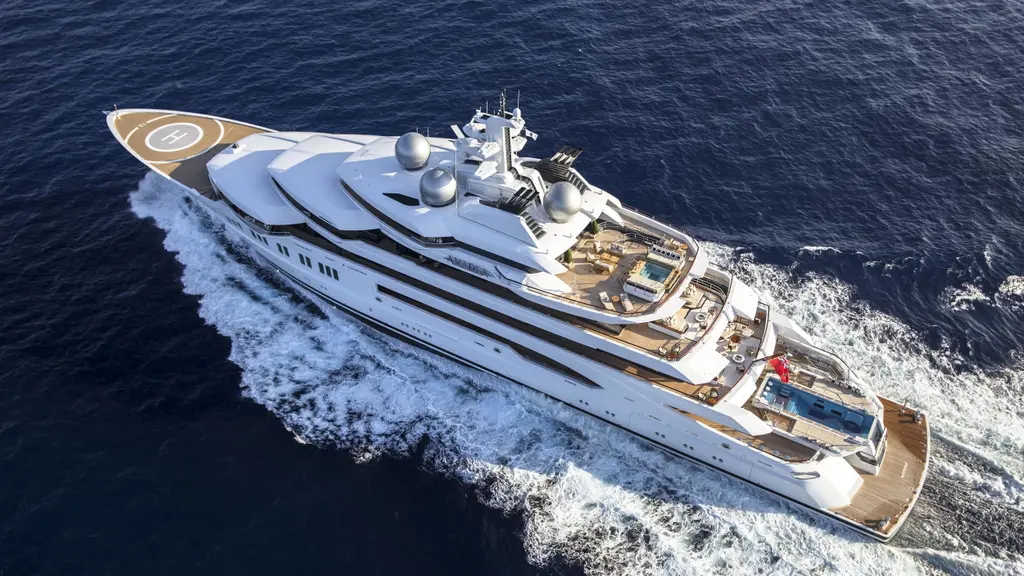 Aerial view of Amadea under way, showing the foredeck helipad and the aft pool