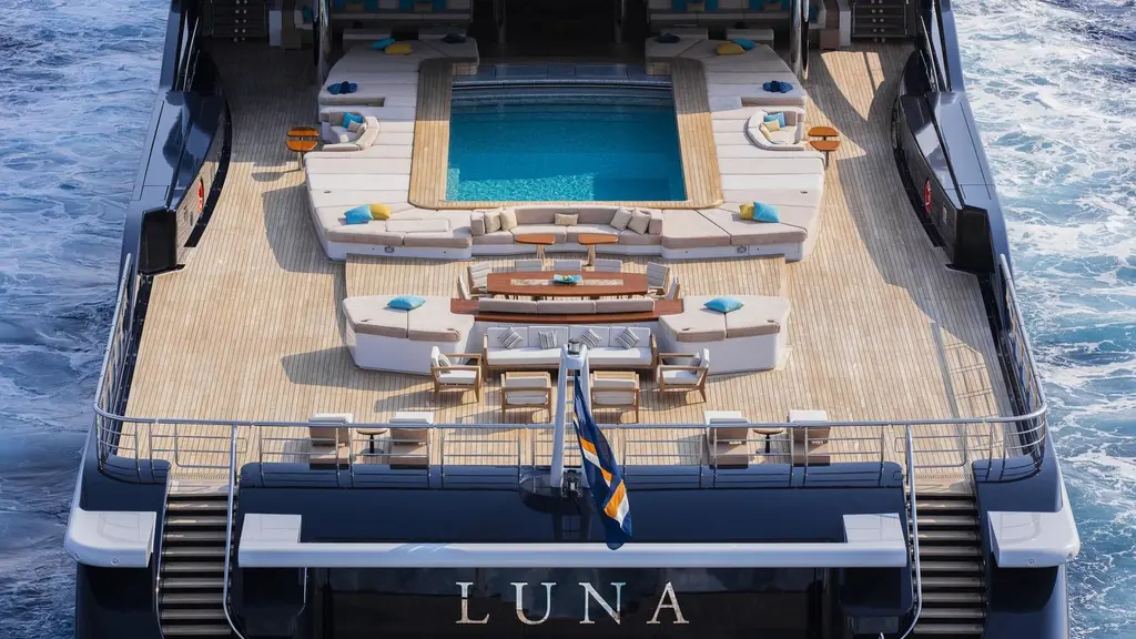 Luna's stern from above, with her name on the transom and the pool surrounded by sunpads