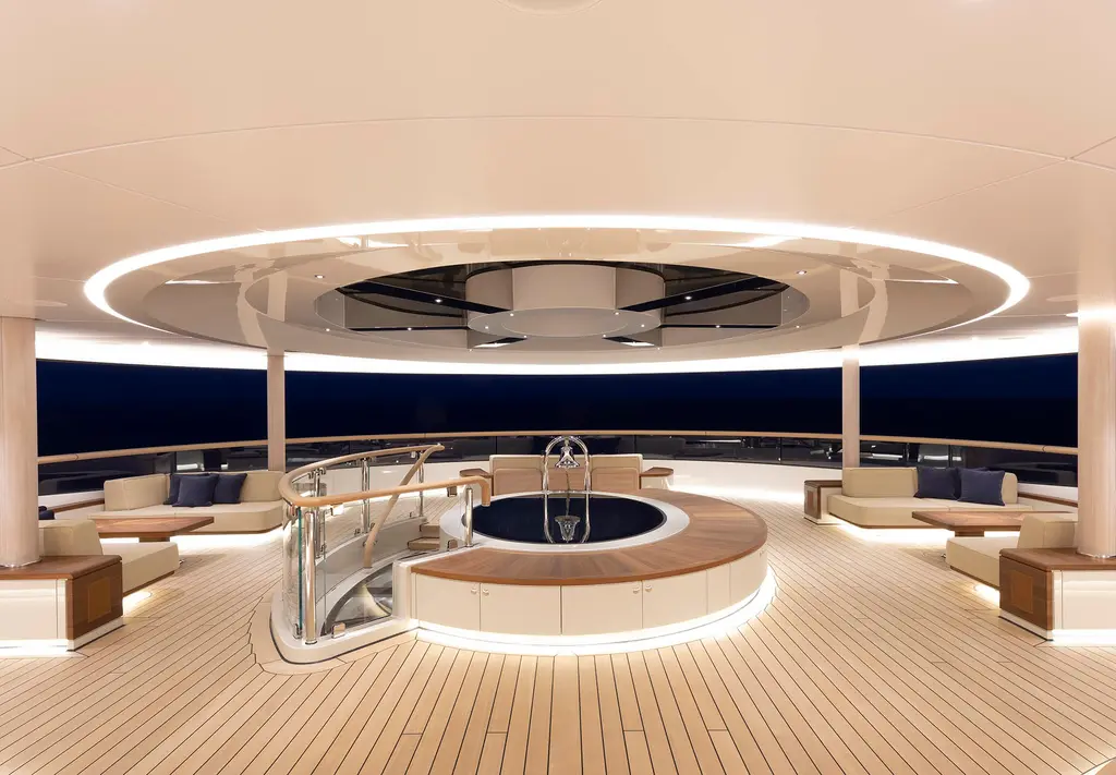 Covered round deck lounge at night with a Jacuzzi in the centre