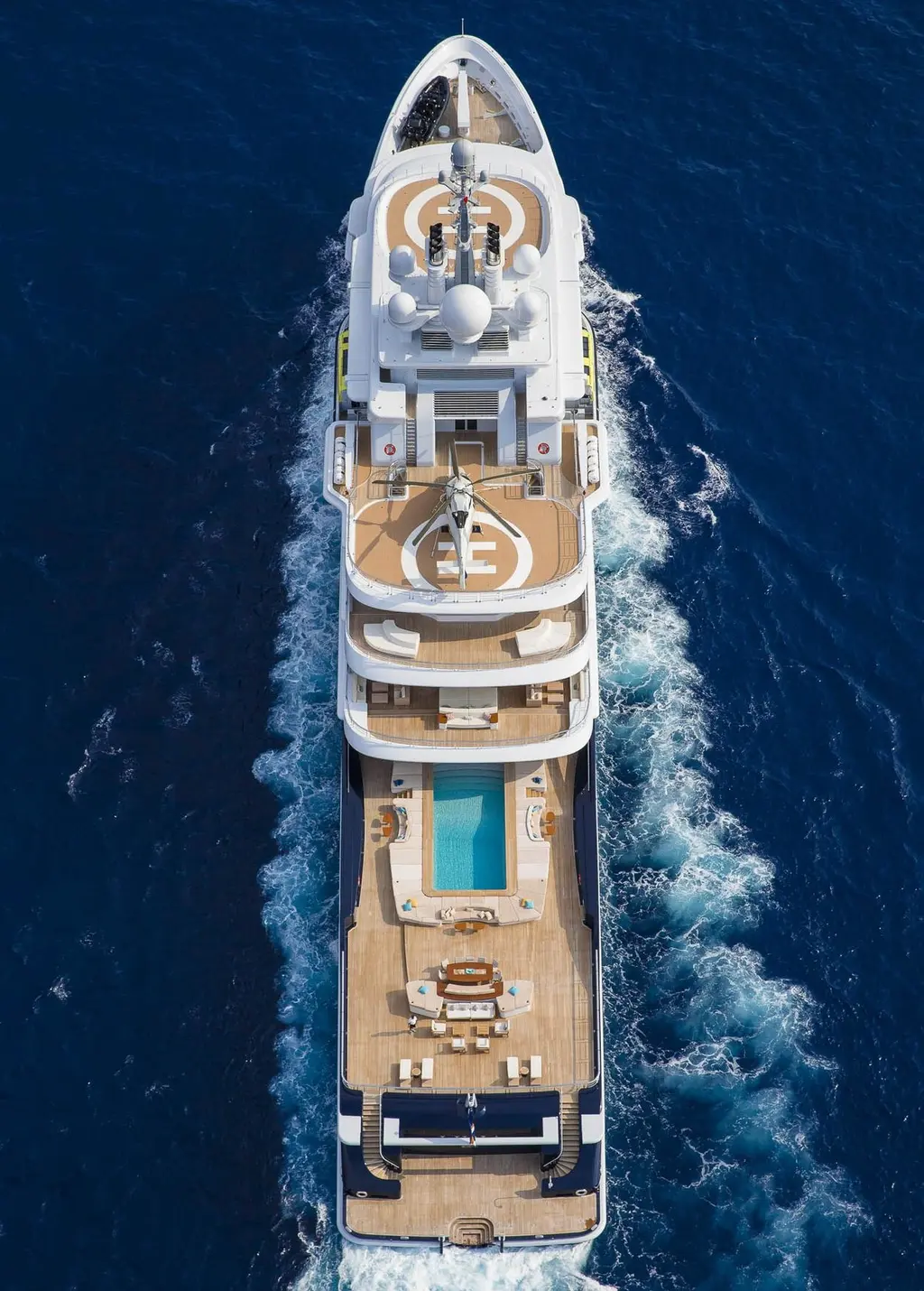 Overhead view of Luna under way, showing the forward and aft helipads, the pool and the long aft deck