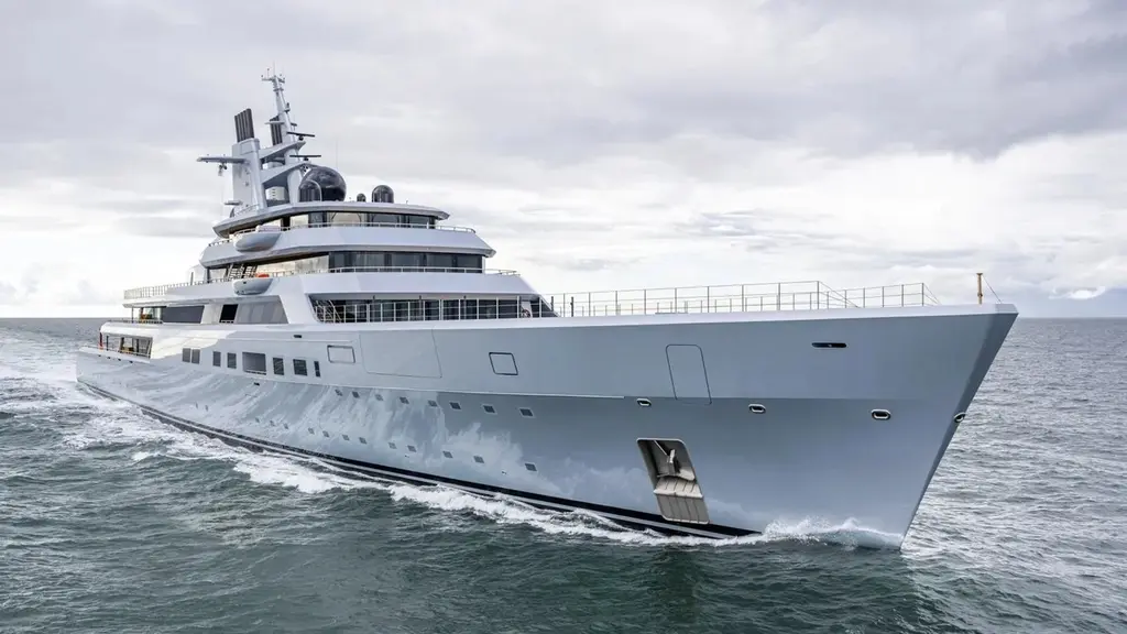 Dragonfly under way in grey sea, three-quarter view from the bow showing the long grey hull and white superstructure
