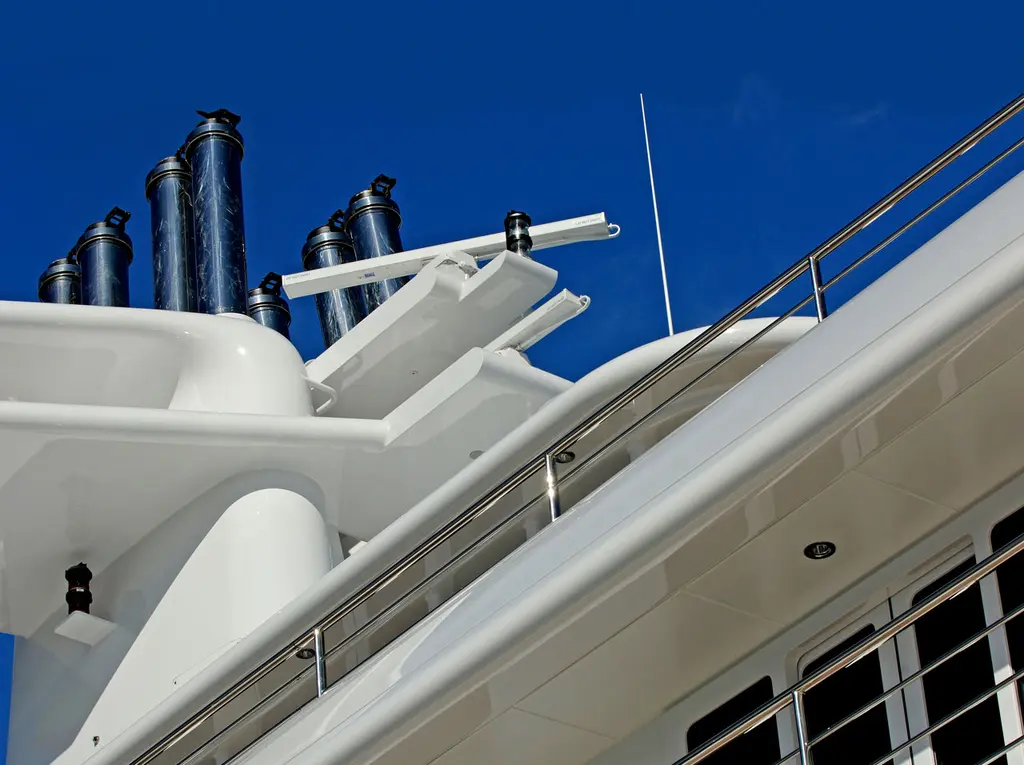 Close-up of the cluster of stainless steel exhaust pipes rising from the funnel above the white superstructure