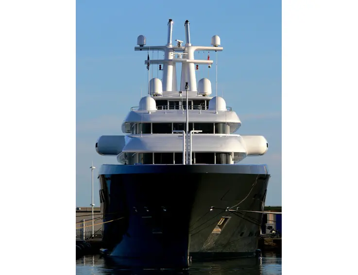 Ice moored in port seen from directly ahead, with her dark hull and white upper decks