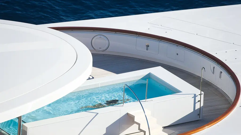 A swimmer in a deck pool seen from above, set in a curved teak deck