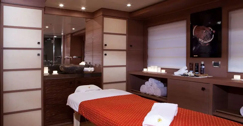 Massage room with a treatment table and wood panelling
