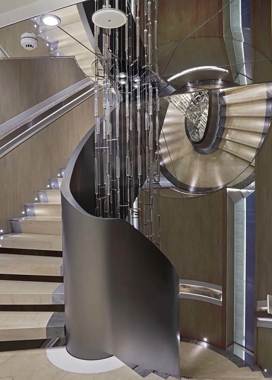 Spiral staircase with a hanging glass-rod light sculpture