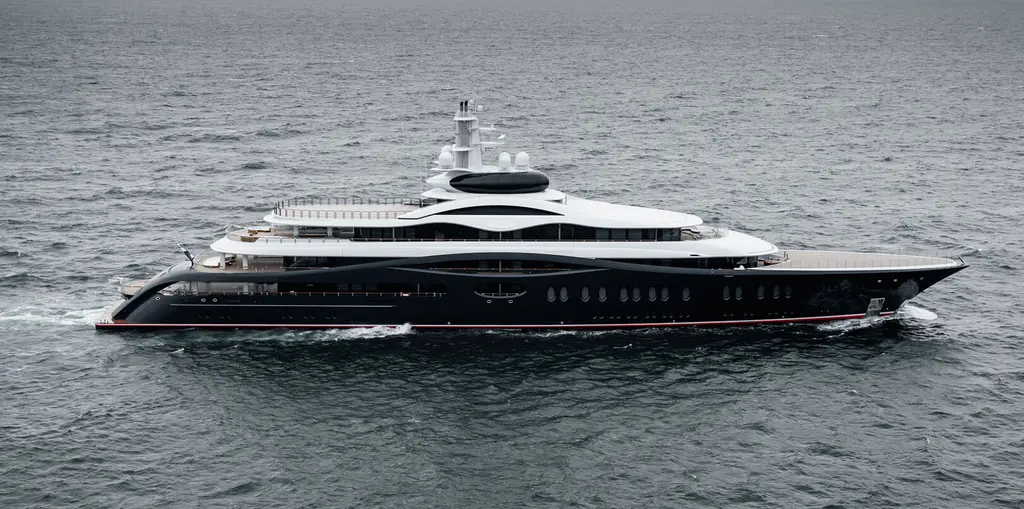 Launchpad under way in profile, dark blue hull with a red waterline stripe and white superstructure topped by a black observation pod