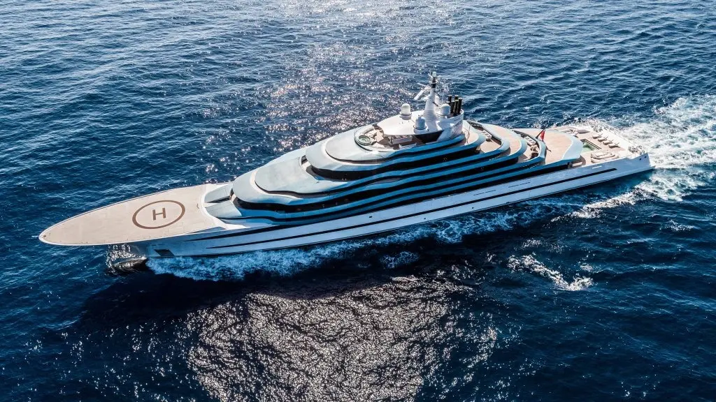 Aerial view of the yacht underway, with the marked helicopter deck on the long foredeck