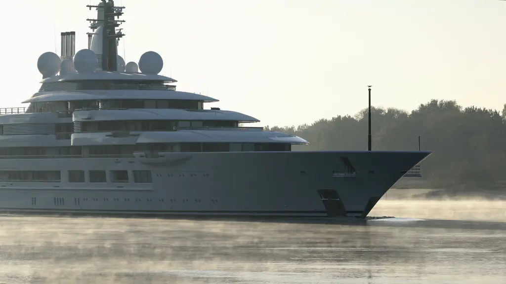 Close view of Scheherazade's bow and stacked upper decks in morning mist, with radar domes above and mist on the water