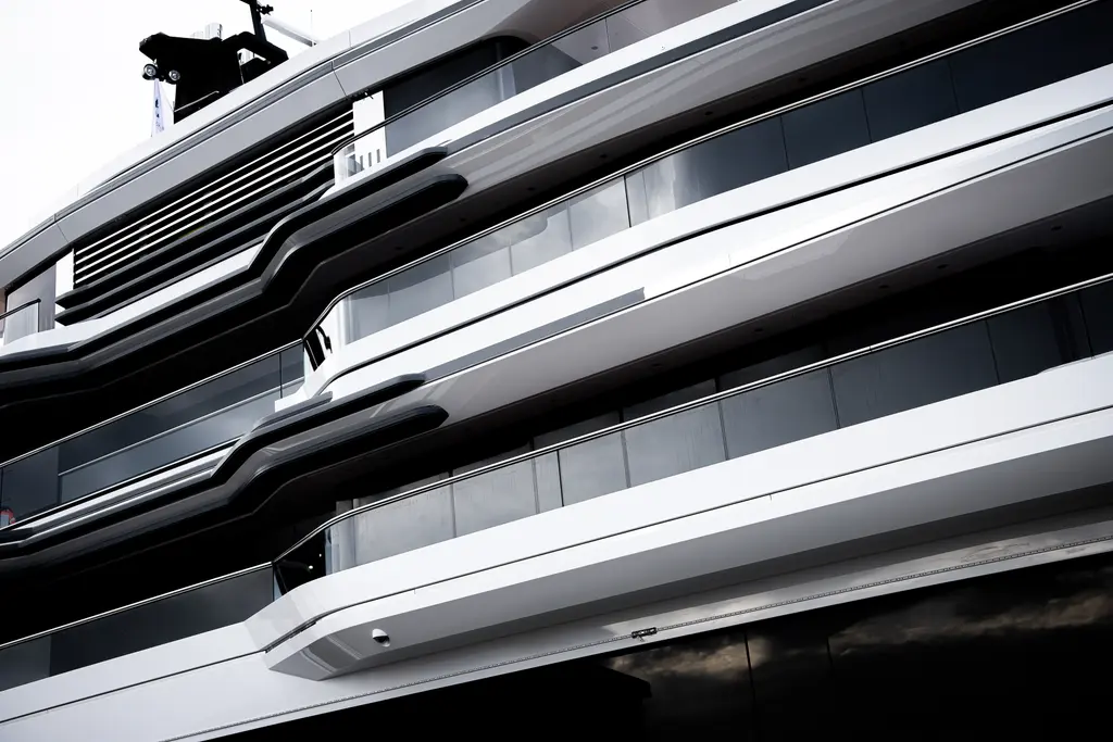 Close-up of the stacked decks of Ulysses, with curved overhangs and floor-to-ceiling glass