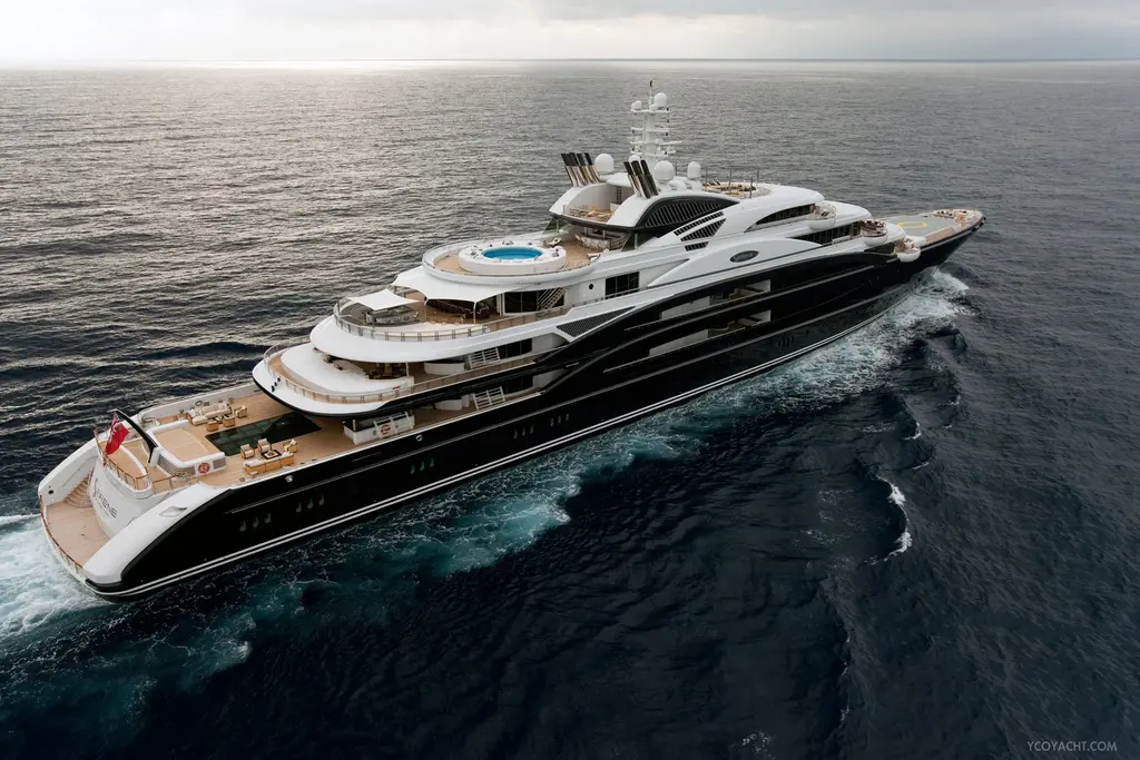 Serene under way, aerial view from the quarter showing the dark blue hull, white superstructure and the round pool on the upper aft deck