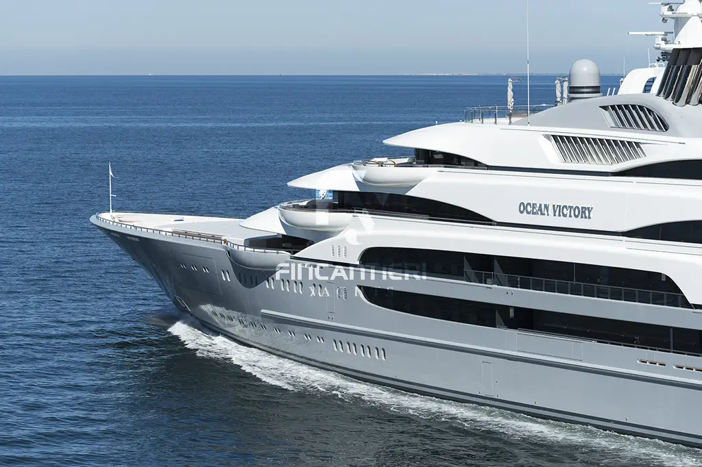 Close view of Ocean Victory's bow and forward superstructure under way, with the yacht's name on the side