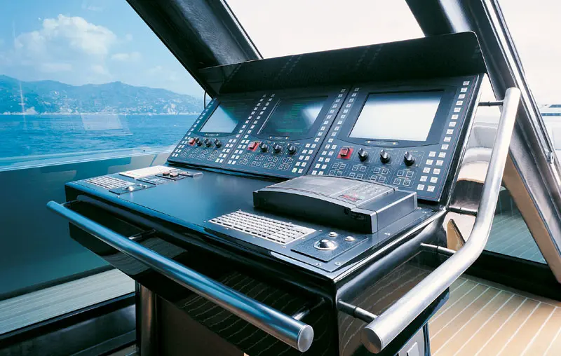 Helm console with screens and rows of switches under the glass roof