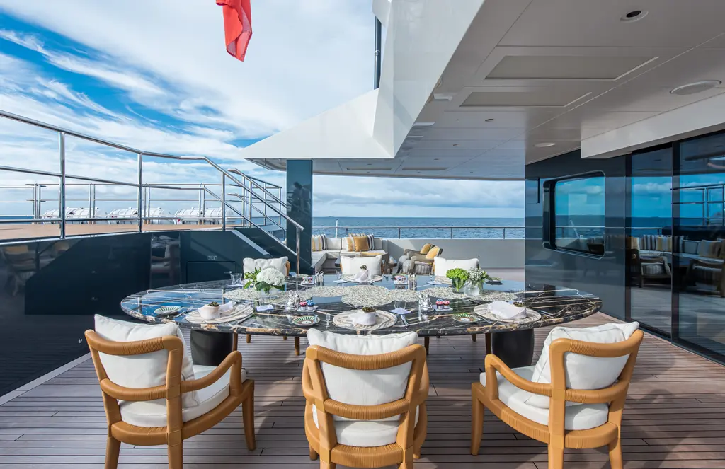 Outdoor dining table on a teak deck with sea views