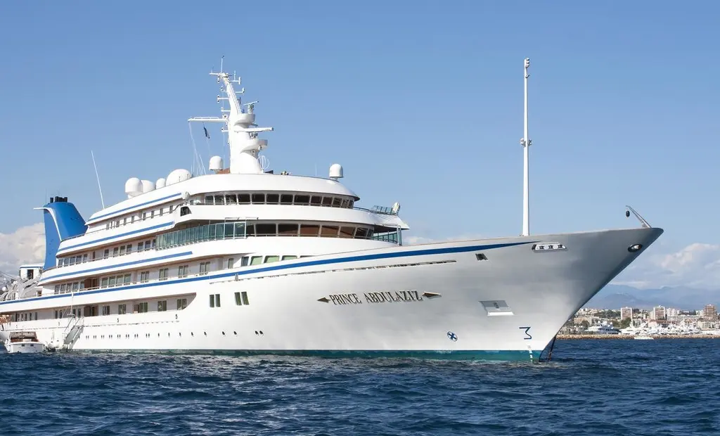 Prince Abdulaziz at anchor seen from the starboard bow, white hull with a blue sheer line and blue funnel