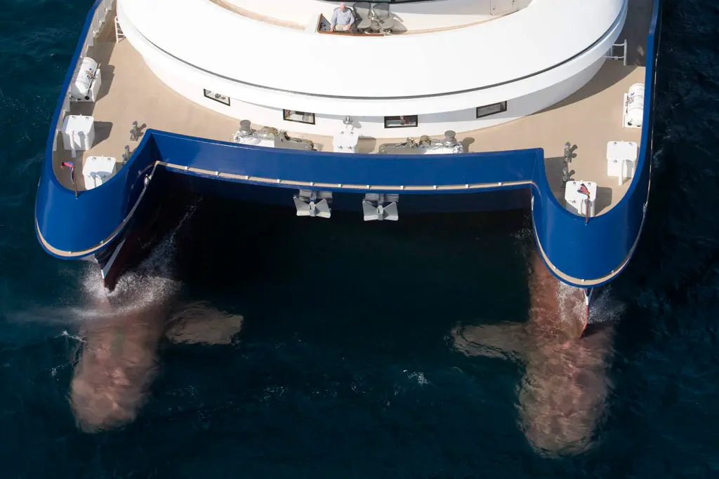 View down onto the stern of Silver Cloud with the two submerged hulls visible under the water on either side