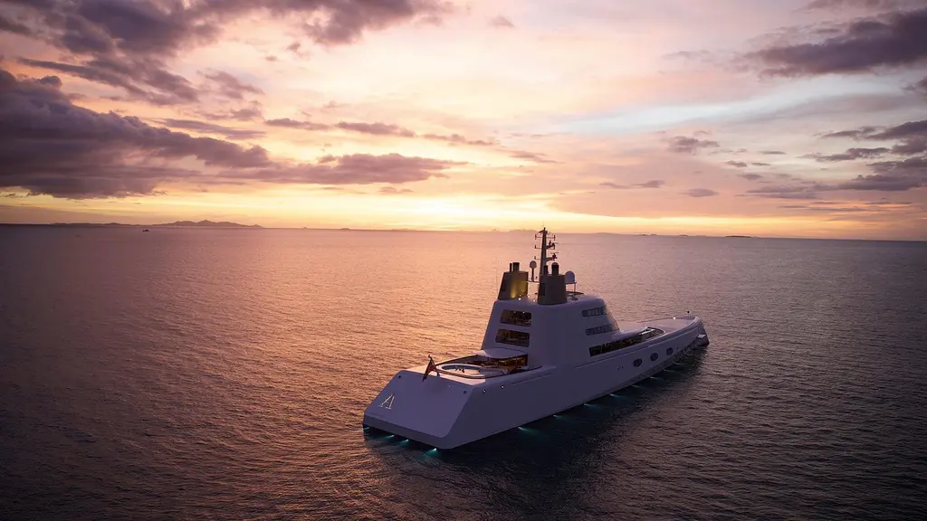 Aerial view of Motor Yacht A from astern at sunset, underwater lights on along the hull