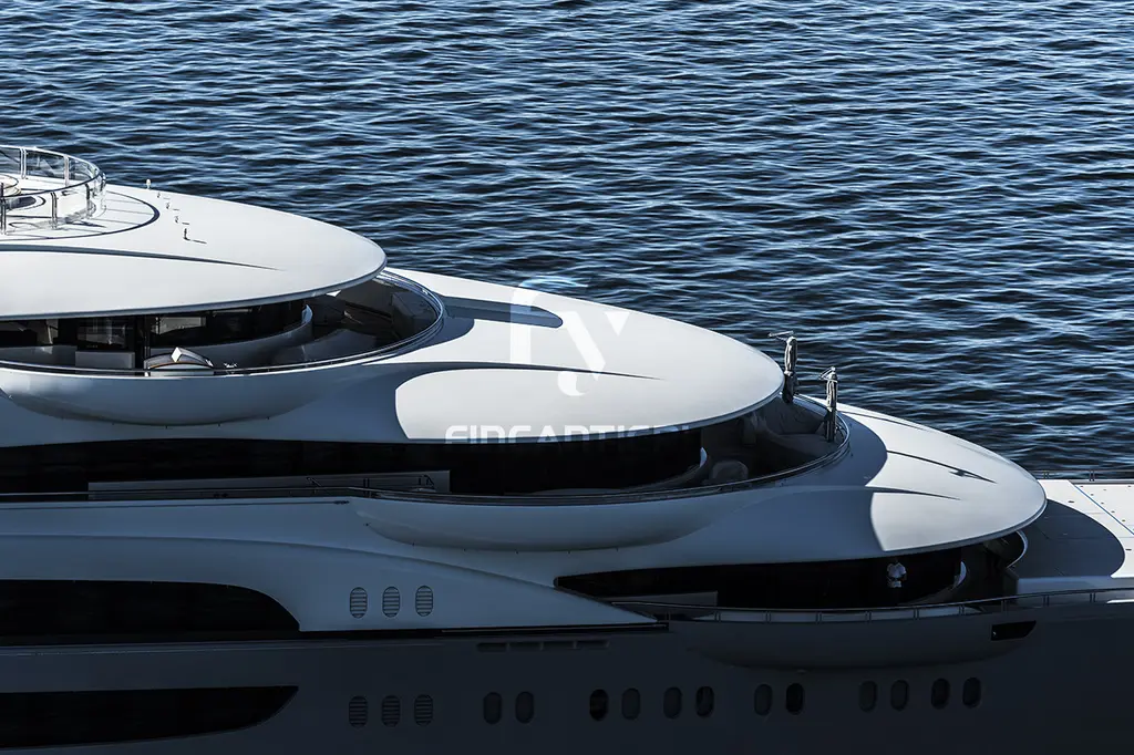 Detail of Ocean Victory's curved white upper-deck overhangs above the water