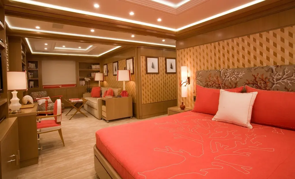 Guest cabin with a double bed and coral-red cover