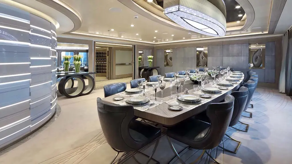 Formal dining room with a long table under an oval chandelier