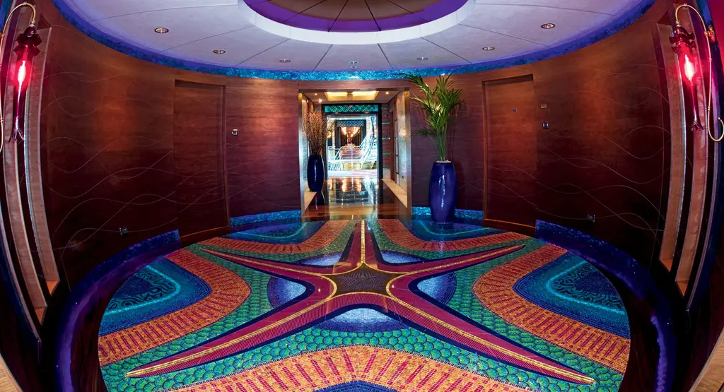 Round lobby with a starfish mosaic on the floor and a corridor beyond