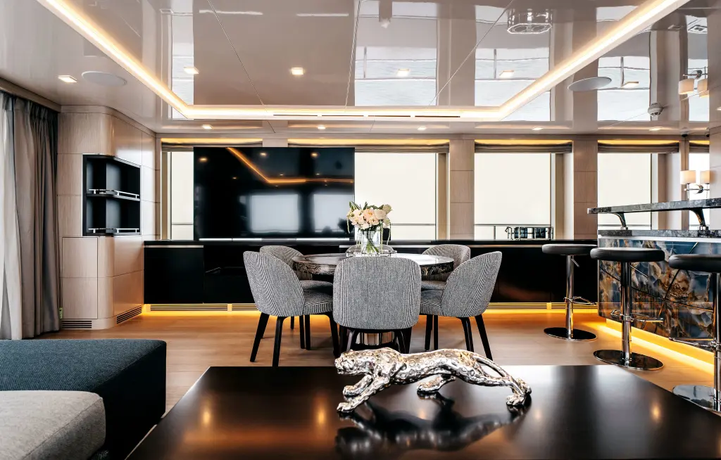 Sky lounge bar with a backlit stone counter, bar stools and a small dining table