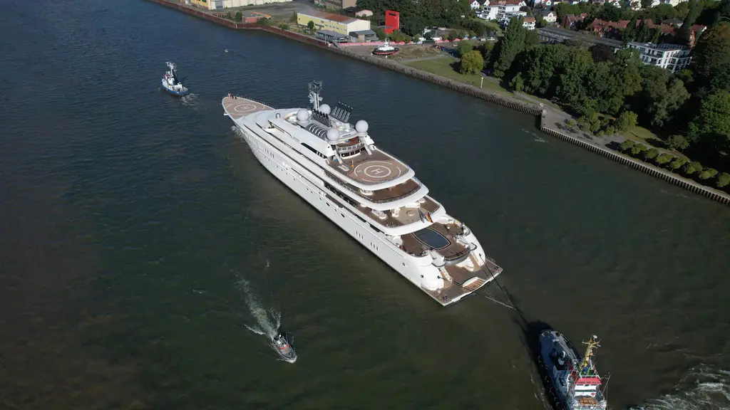 Aerial view of Opera under tow on a river, showing the helipads on the foredeck and on the upper deck aft