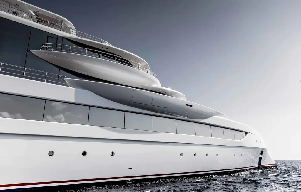 Low view along the side of Excellence at sea, showing her curved, overhanging upper decks and the long glazed superstructure