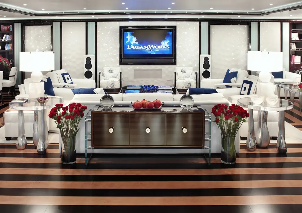 Main salon with white sofas, striped floor and red flowers